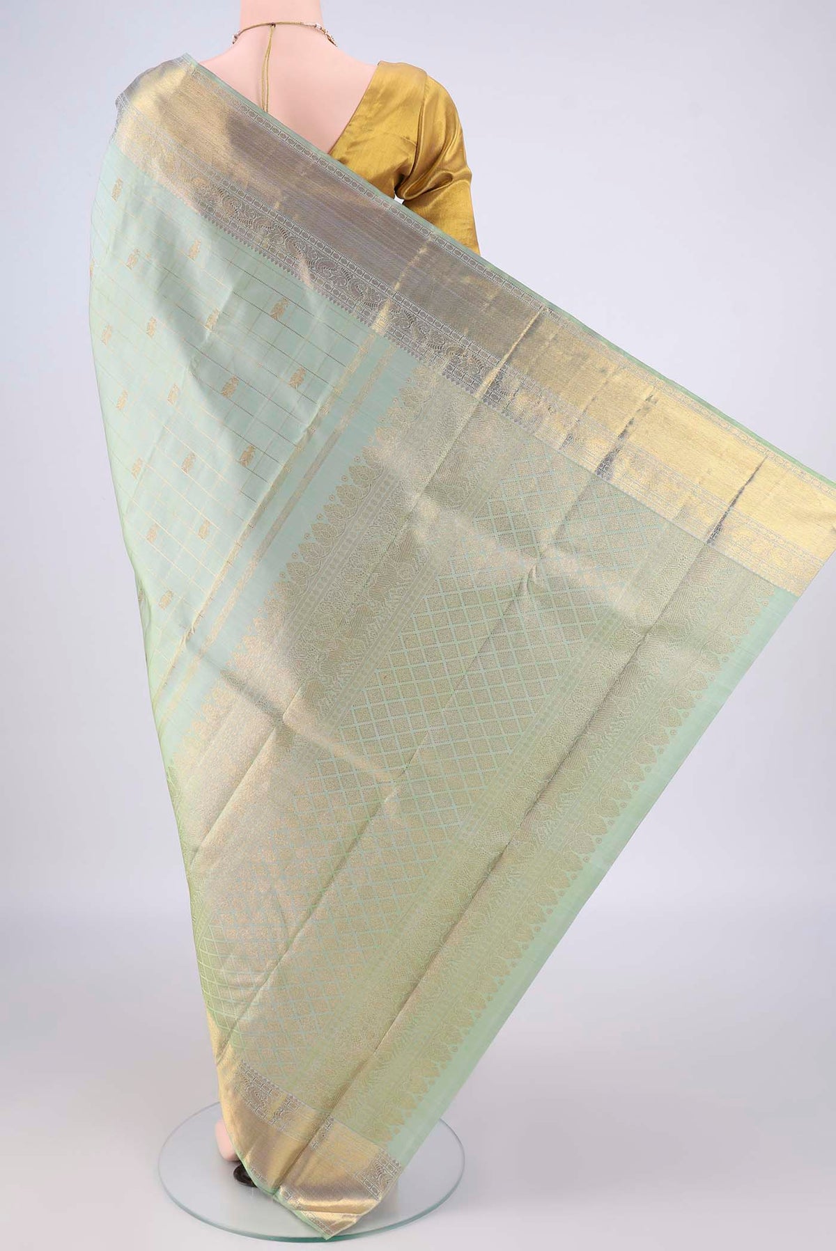 Flat view of Pure Silk Pure Zari Pista Green Kanjivaram Saree with Checked design on the body and Zari Border. 
