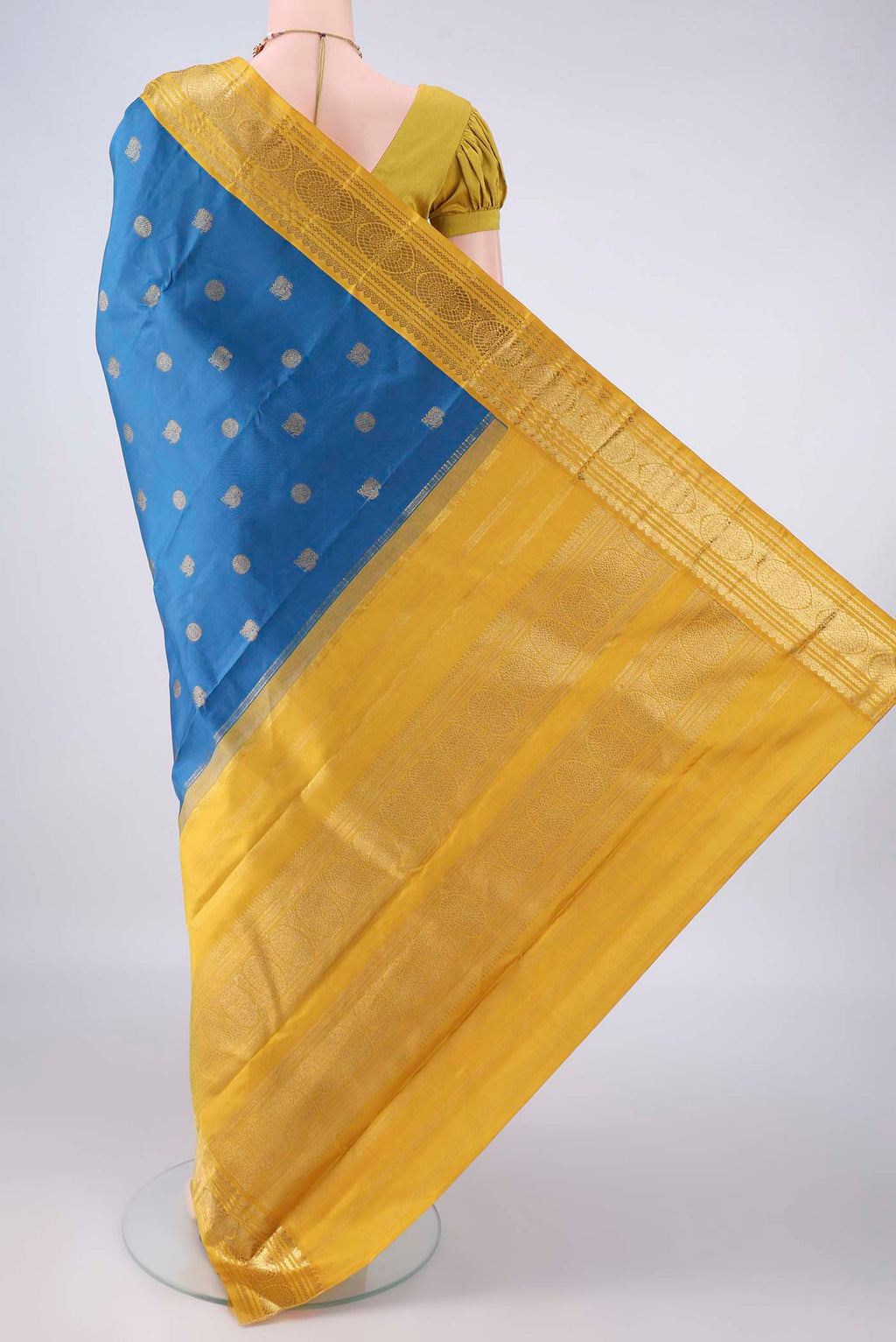 Flat view of Pure Silk Blue Kanjivaram Saree with Zari Butta on the body and Zari Border. 