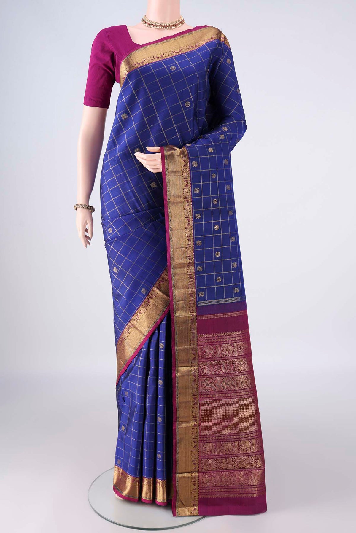 Pure Silk Pure Zari Royal Blue Kanjivaram Saree with Checked design on the body and Zari Border.  displayed on a mannequin