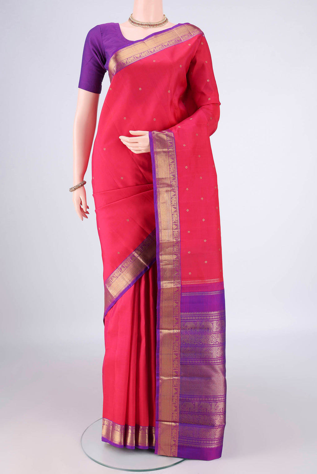 Pure Silk Pure Zari Dark Pink Kanjivaram Saree with Zari Butta on the body and Zari Border.  displayed on a mannequin