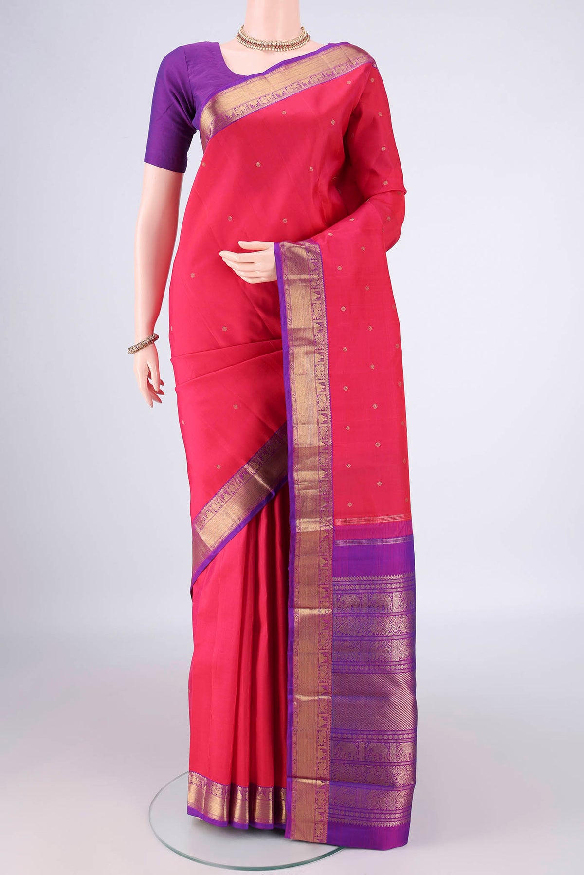 Pure Silk Pure Zari Dark Pink Kanjivaram Saree with Zari Butta on the body and Zari Border.  displayed on a mannequin