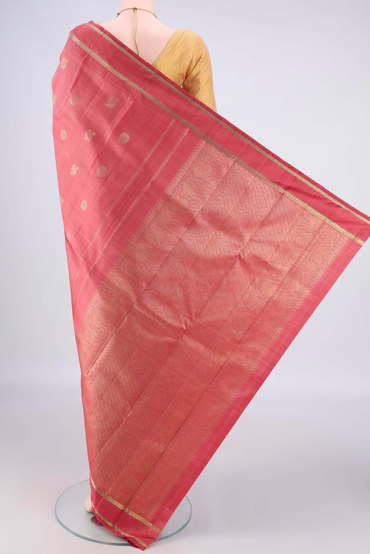 Flat view of Pure Silk Pure Zari Coral Kanchipuram Saree with Zari Butta on the body and Zari Border. 