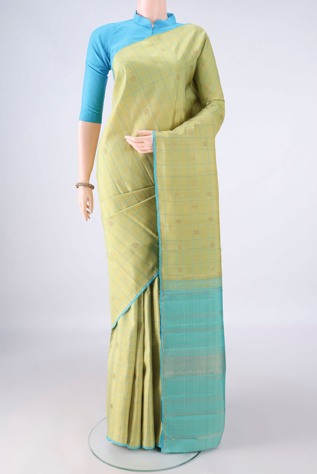 Pure Silk Light Green Kanjivaram Saree with Checked design on the body and Without Border.  displayed on a mannequin