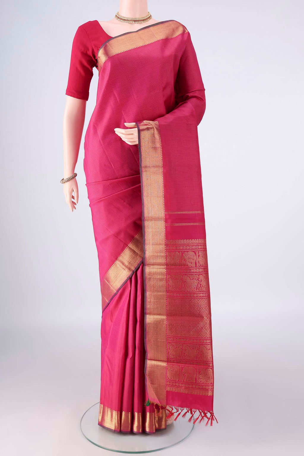 Pure Silk Pure Zari Pink Kanjivaram Saree with Stripes on the body and Zari Border.  displayed on a mannequin