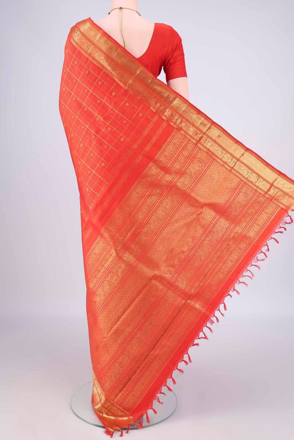 Flat view of Pure Silk Pure Zari Orange Kanjivaram Saree with Checked design on the body and Zari Border. 
