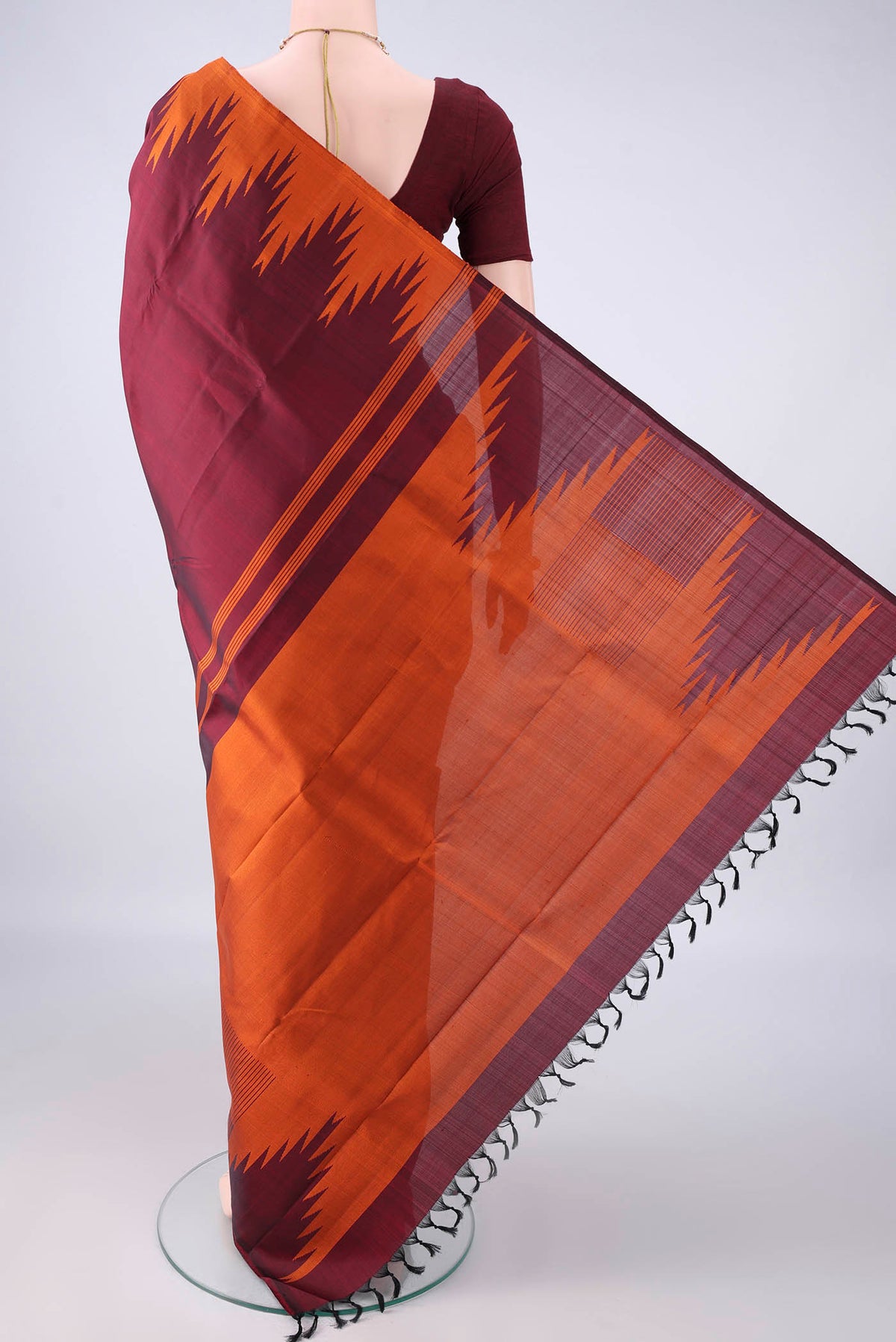 Flat view of Pure Silk Maroon Kanjivaram Saree with Plain Body and Temple Border. 