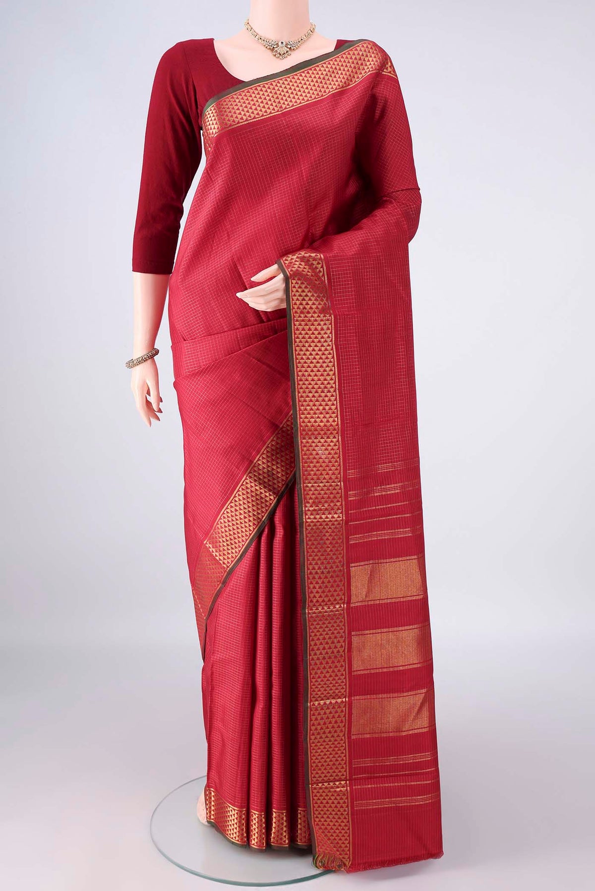 Pure Silk Red Kanjivaram Saree with Checked design on the body and Zari Border.  displayed on a mannequin