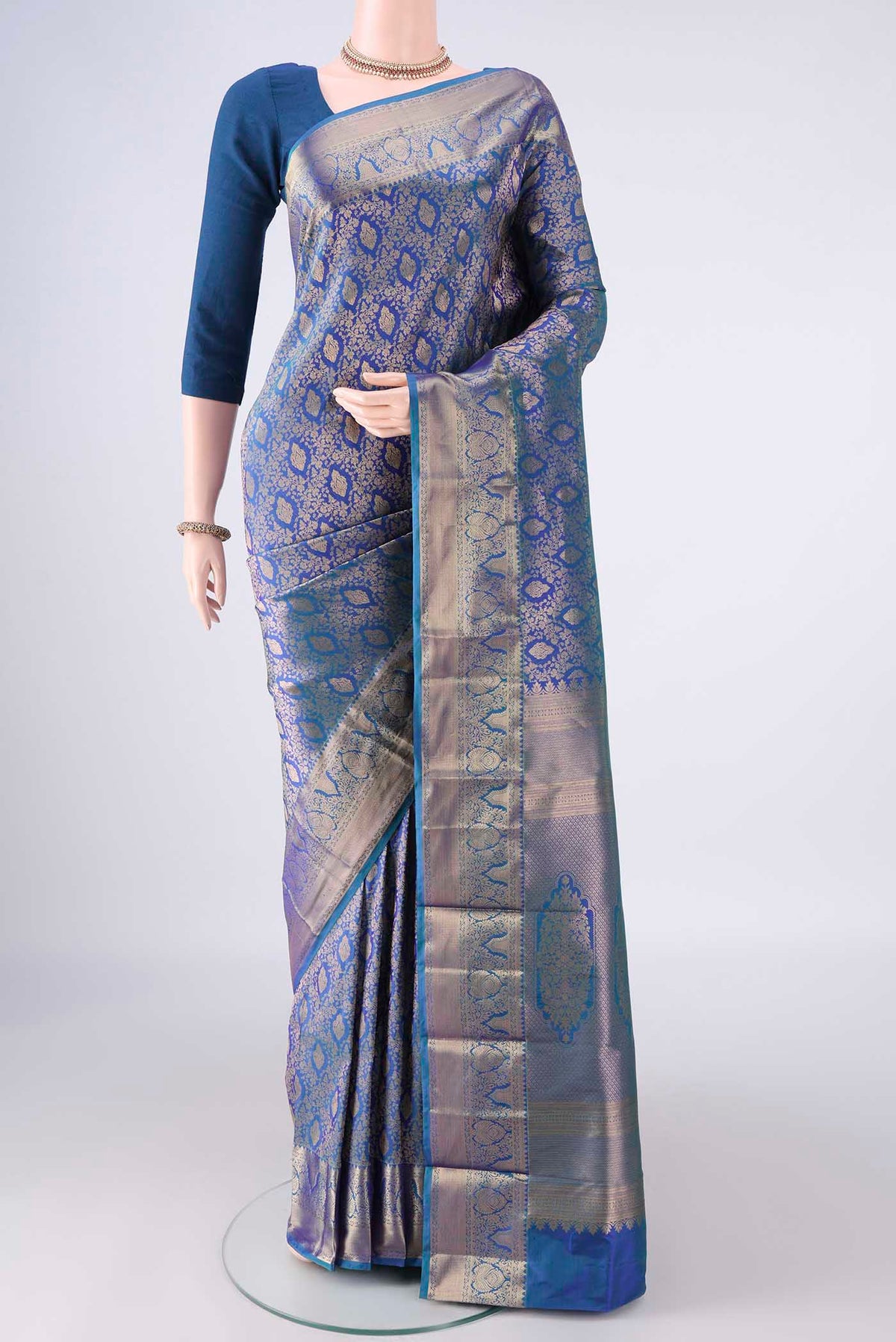 Pure Silk Blue Kanjivaram Saree with Zari Brocade on the body and Zari Border.  displayed on a mannequin