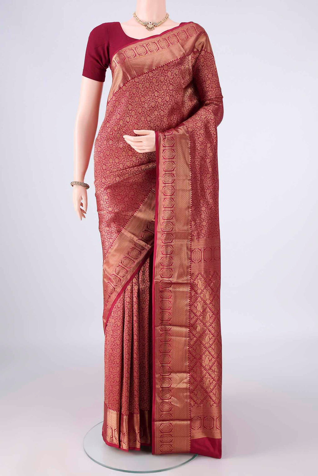 Pure Silk Maroon Kanjivaram Saree with Zari Brocade on the body and Zari Border.  displayed on a mannequin