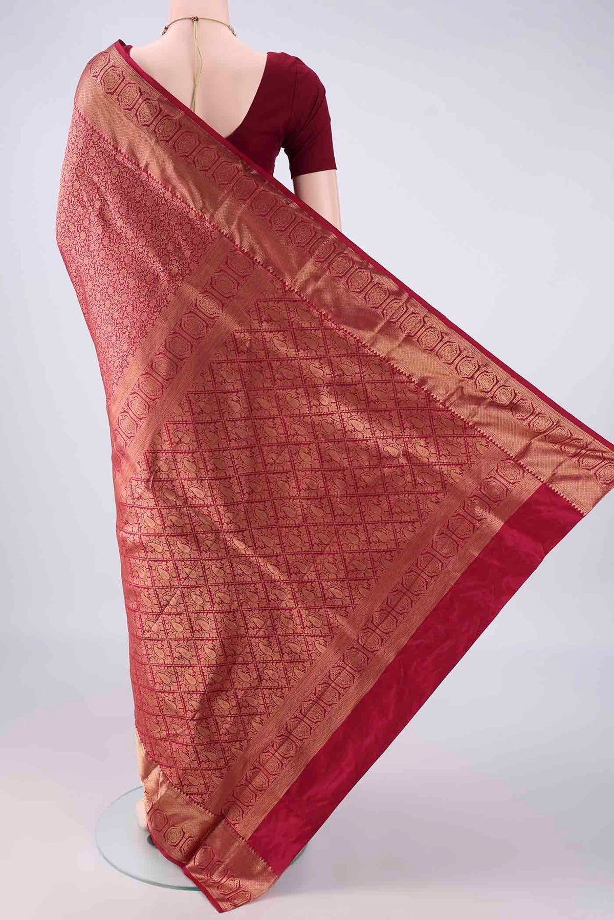 Flat view of Pure Silk Maroon Kanjivaram Saree with Zari Brocade on the body and Zari Border. 