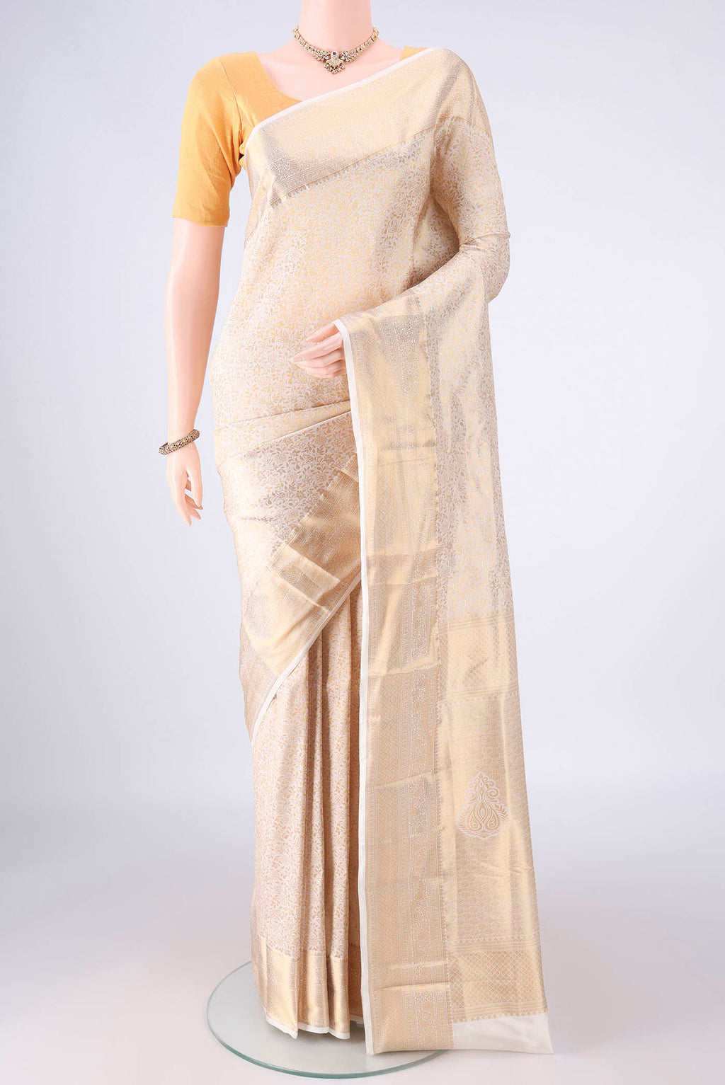 Pure Silk Off White Kanjivaram Saree with Zari Brocade on the body and Zari Border.  displayed on a mannequin