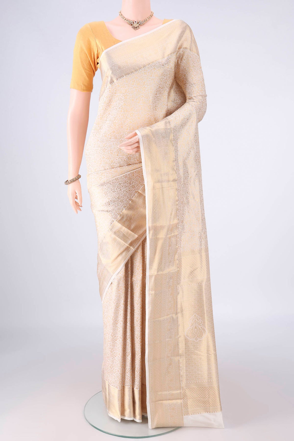 Pure Silk Off White Kanjivaram Saree with Zari Brocade on the body and Zari Border.  displayed on a mannequin