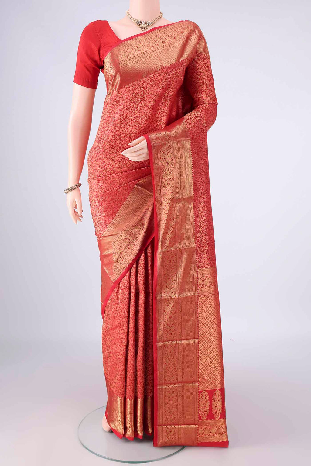Pure Silk Red Kanjivaram Saree with Zari Brocade on the body and Zari Border.  displayed on a mannequin