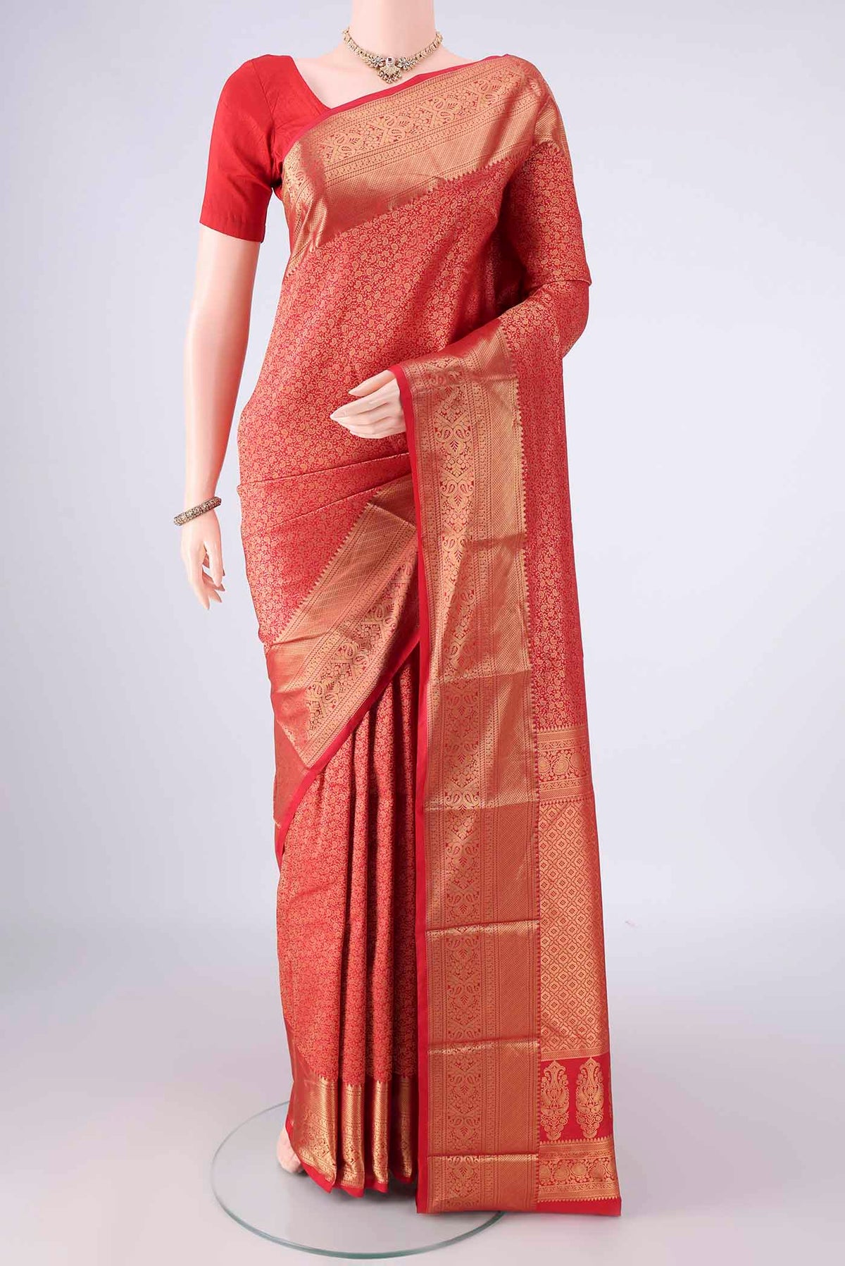 Pure Silk Red Kanjivaram Saree with Zari Brocade on the body and Zari Border.  displayed on a mannequin