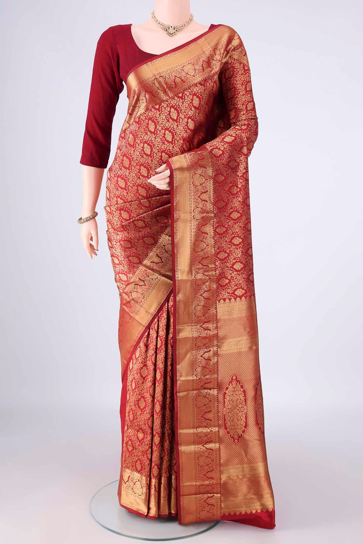 Pure Silk Maroon Kanjivaram Saree with Zari Brocade on the body and Zari Border.  displayed on a mannequin