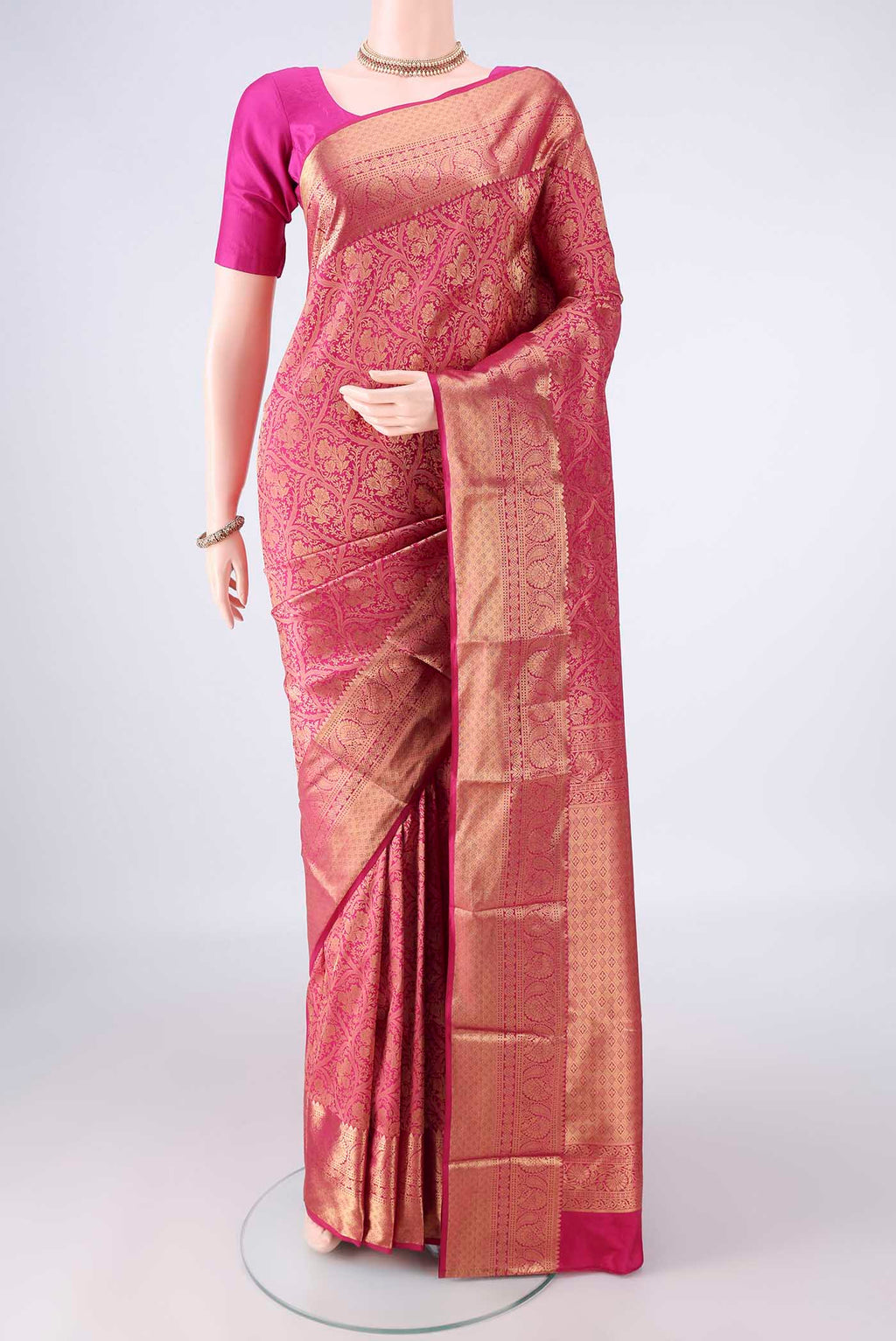 Pure Silk Rani Pink Kanjivaram Saree with Zari Brocade on the body and Zari Border.  displayed on a mannequin