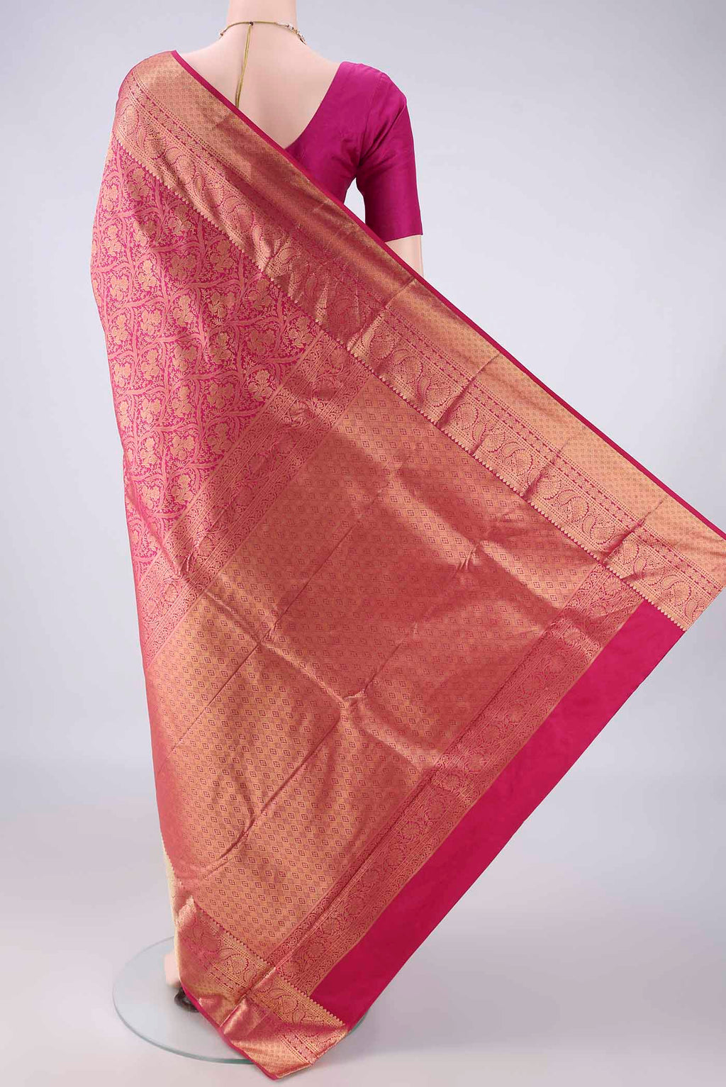 Flat view of Pure Silk Rani Pink Kanjivaram Saree with Zari Brocade on the body and Zari Border. 
