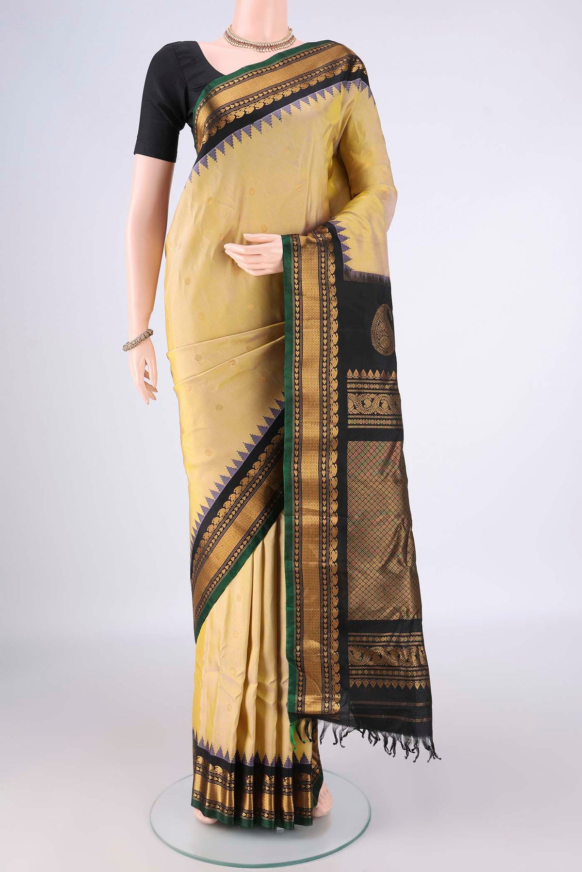 Pure Silk Sandal Gadwal Saree with Zari Butta on the body and Zari Border.  displayed on a mannequin