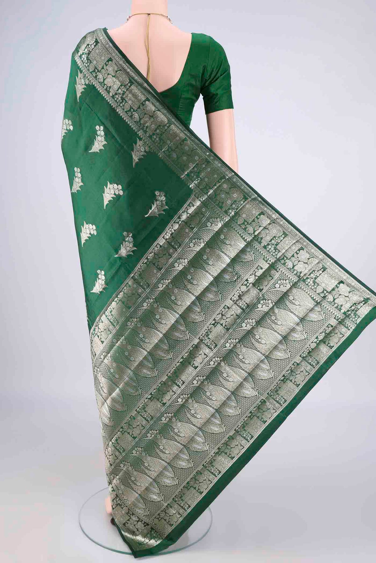 Flat view of Pure Silk Bottle Green Banarasi Raw Saree with Zari Butta on the body and Zari Border. 