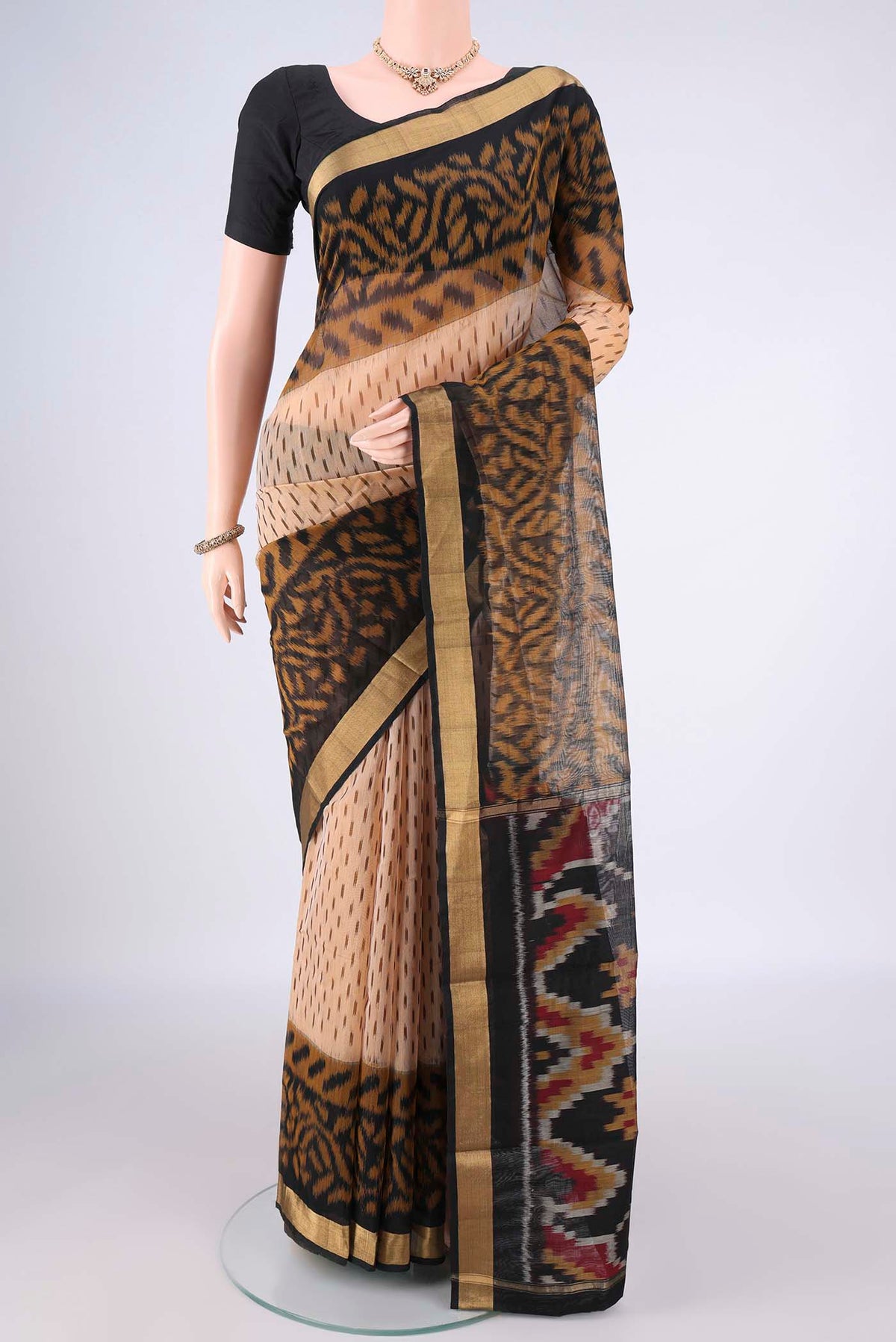 Dark Beige Silk Cotton Saree with Ikat Print on the body and Zari Border.  displayed on a mannequin