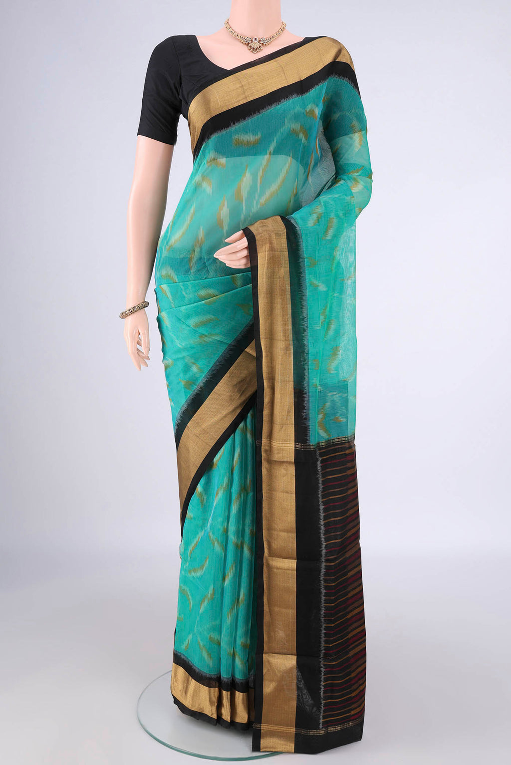 Sea Green Silk Cotton Saree with Ikat Print on the body and Zari Border.  displayed on a mannequin
