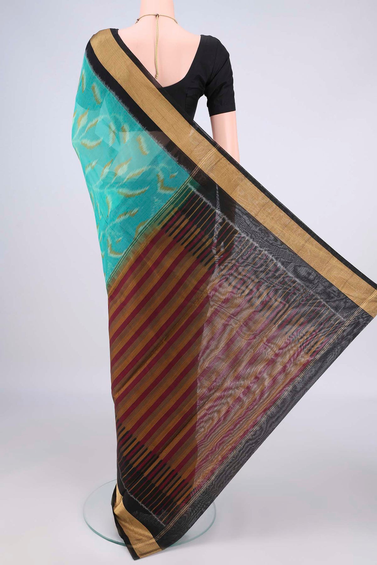 Flat view of Sea Green Silk Cotton Saree with Ikat Print on the body and Zari Border. 