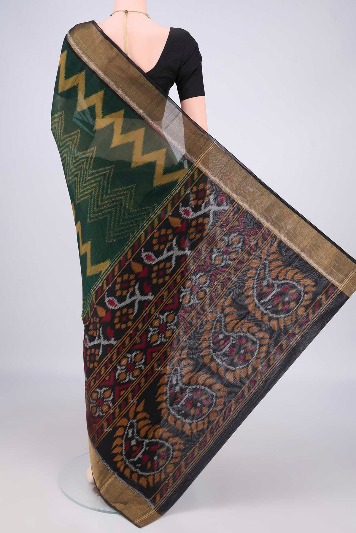 Flat view of Bottle Green Silk Cotton Saree with Ikat Print on the body and Zari Border. 