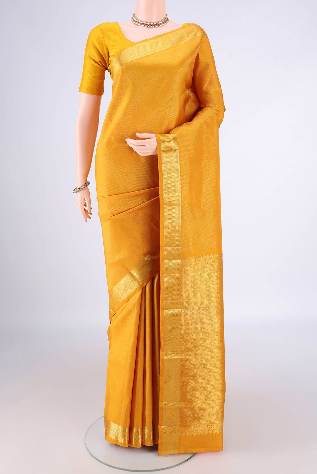 Mustard Kanchipuram Tissue Saree with Stripes on the body and Zari Border.  displayed on a mannequin