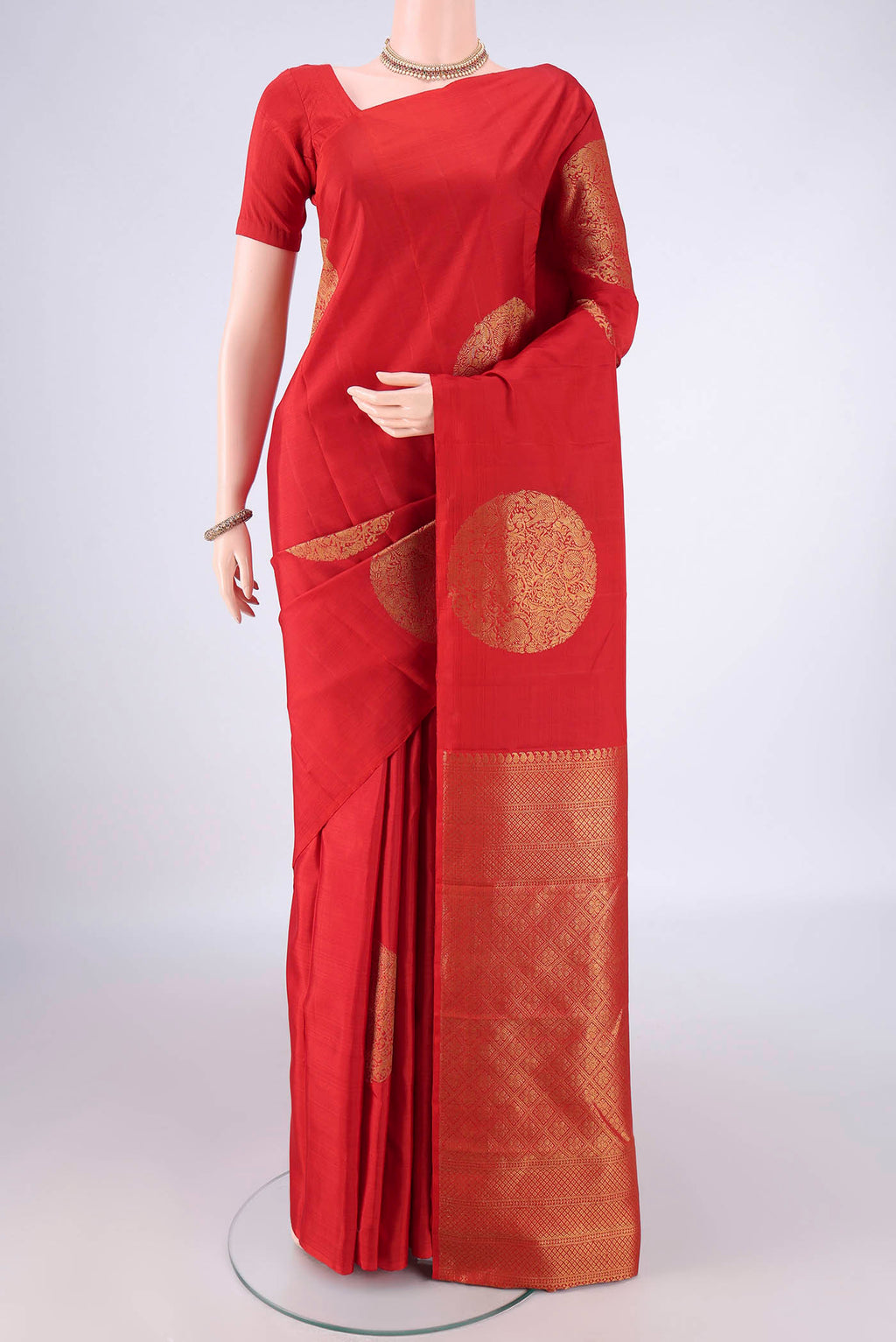Pure Silk Red Kanchipuram Saree with Zari Butta on the body and Without Border.  displayed on a mannequin