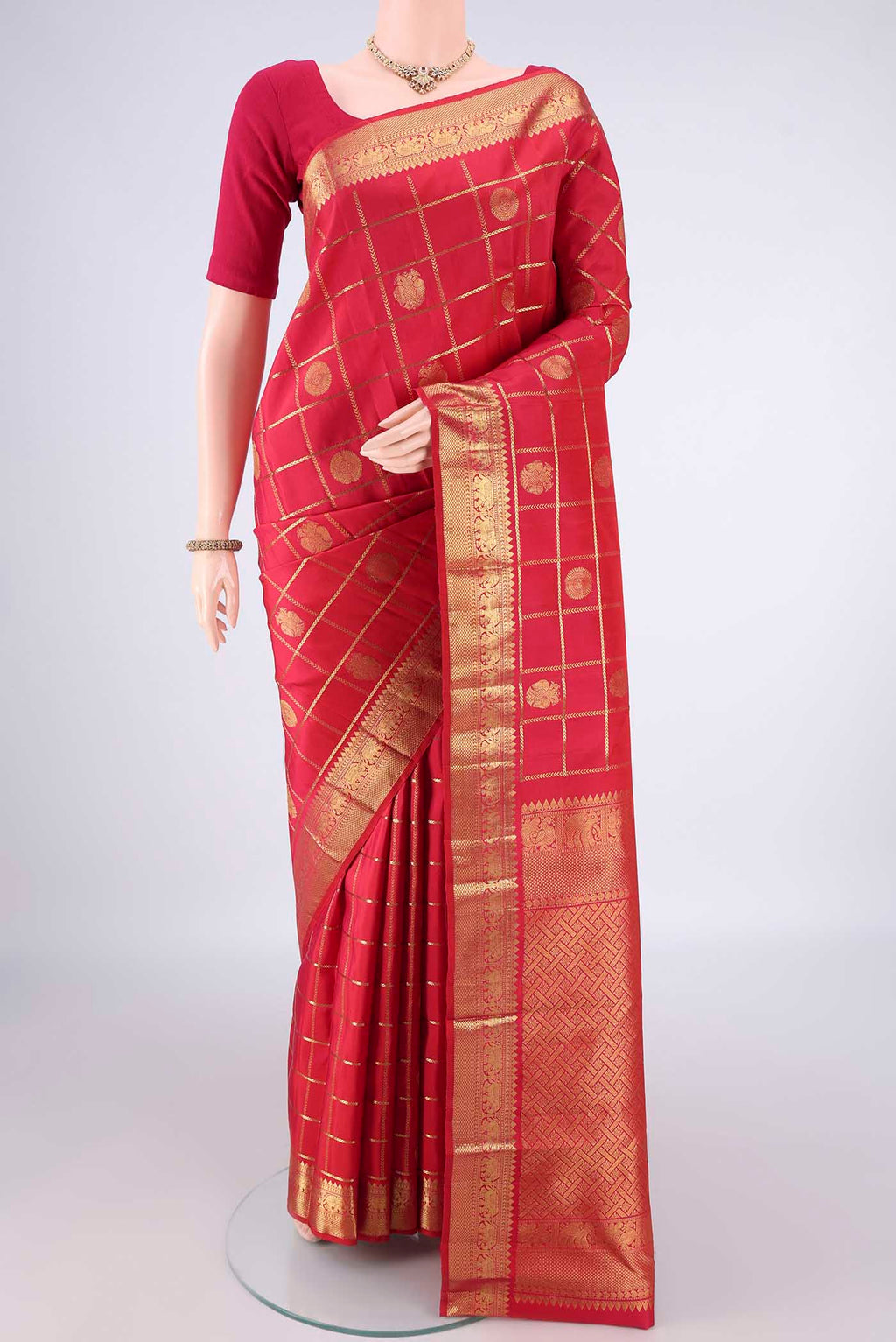 Pure Silk Red Kanjivaram Saree with Checked design on the body and Zari Border.  displayed on a mannequin