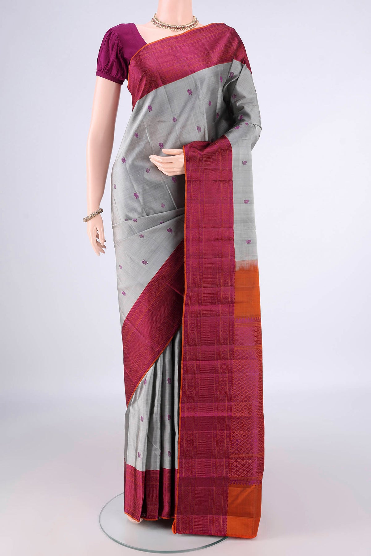 Pure Silk Grey Kanchipuram Saree with Thread Butta on the body and Thread Border.  displayed on a mannequin
