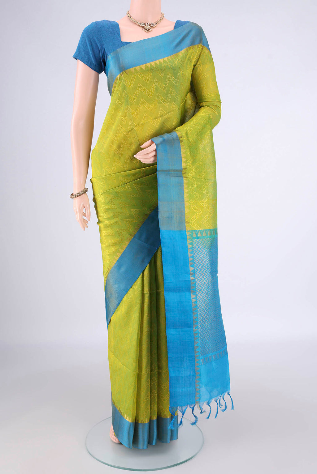 Acid Green Coimbatore Cotton Saree with Jacquard design on the body and Zari Border.  displayed on a mannequin