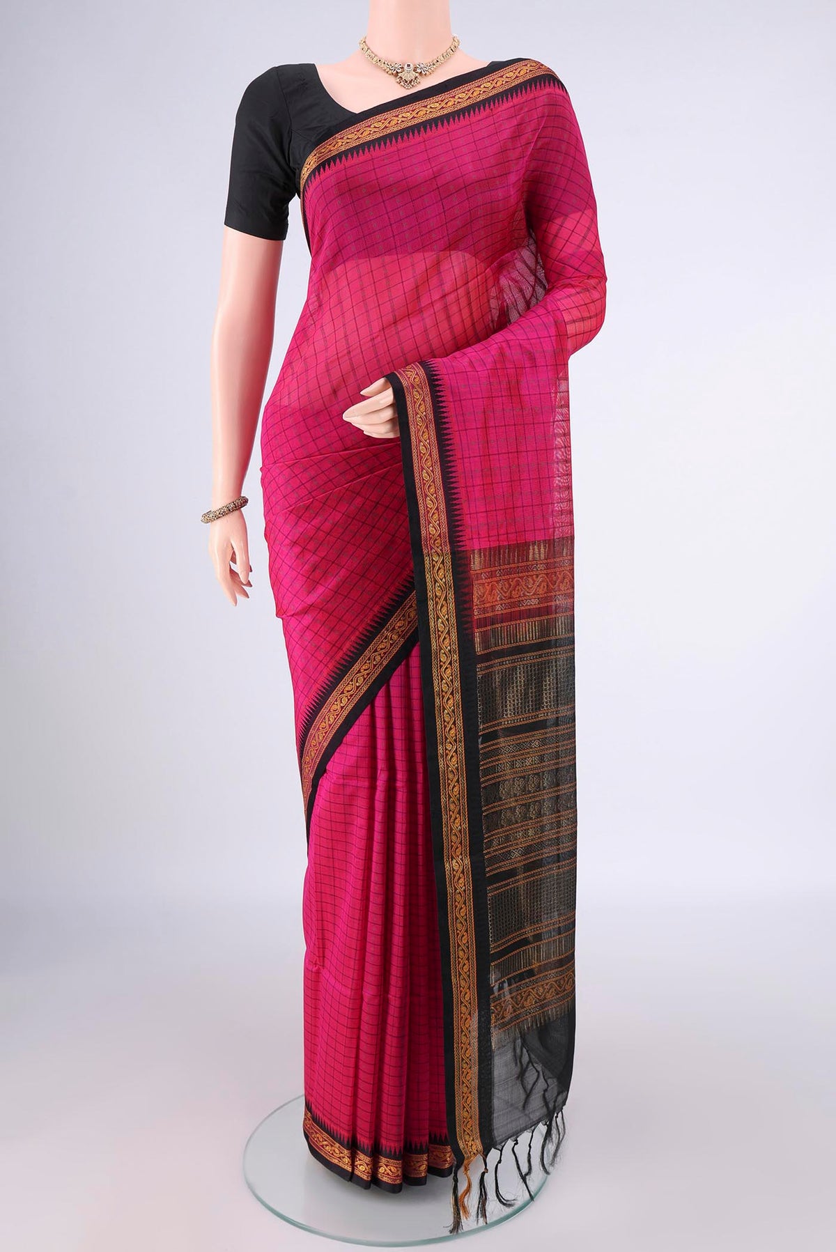 Rani Pink Coimbatore Cotton Saree with Checked design on the body and Zari Border.  displayed on a mannequin