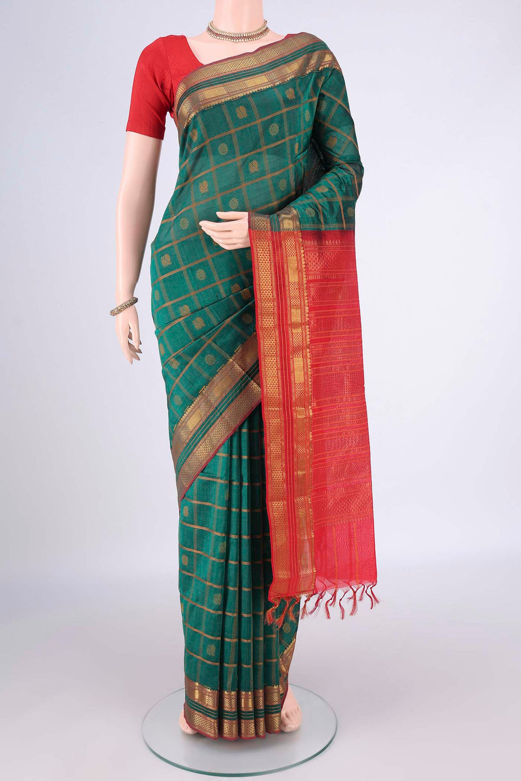 Green Coimbatore Cotton Saree with Checked design on the body and Zari Border.  displayed on a mannequin