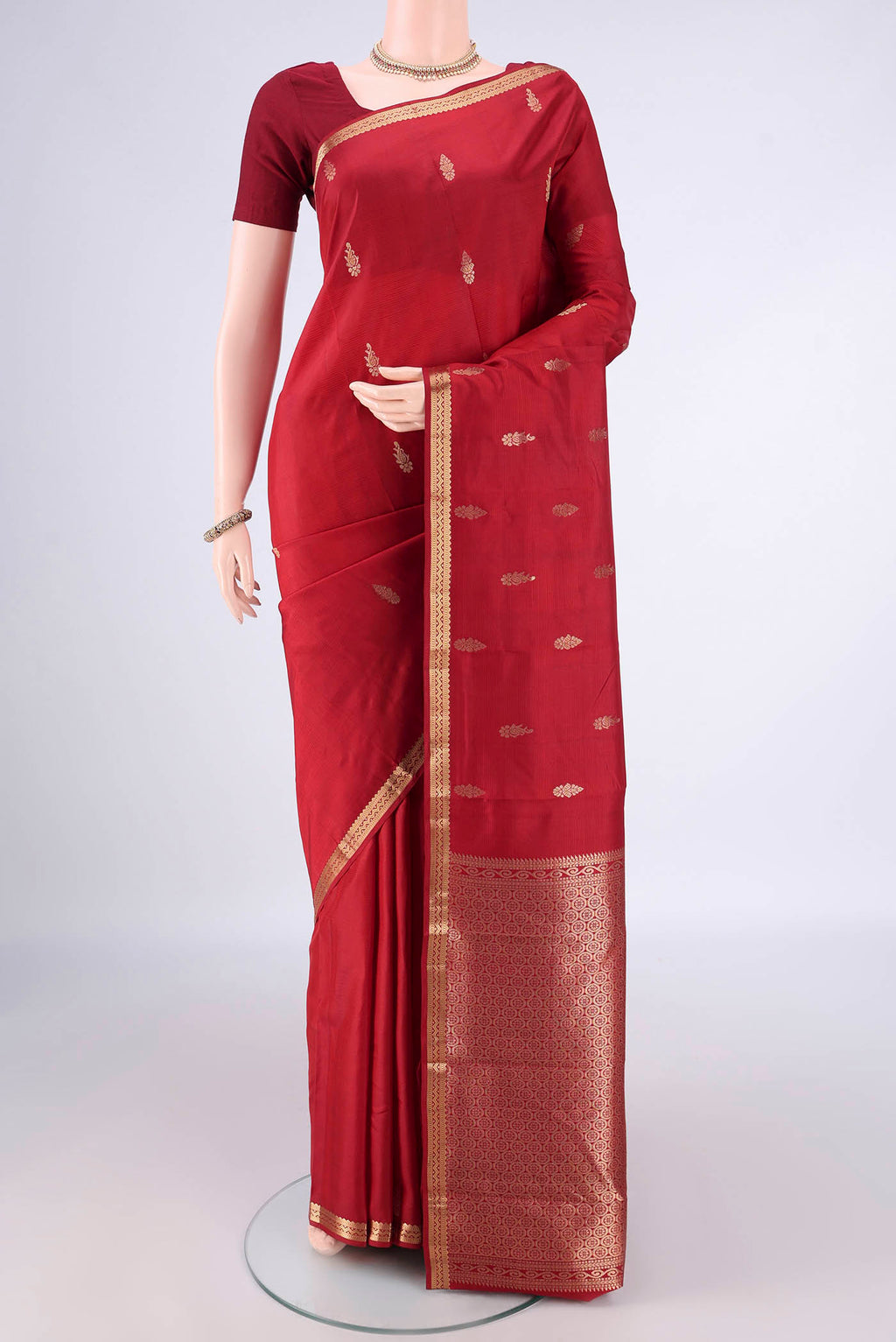 Pure Silk Deep Red Kanjivaram Saree with Zari Butta on the body and Zari Border.  displayed on a mannequin