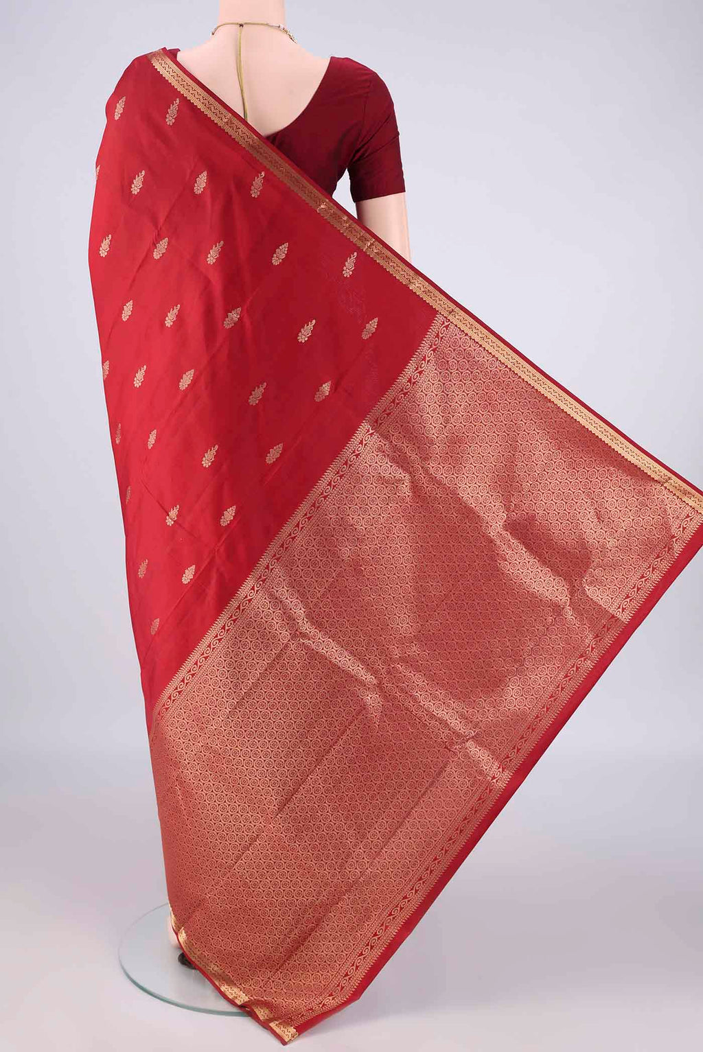 Flat view of Pure Silk Deep Red Kanjivaram Saree with Zari Butta on the body and Zari Border. 