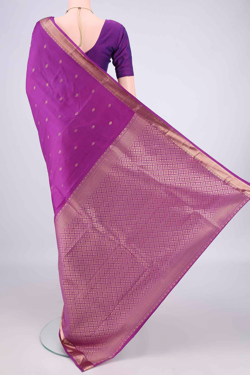 Flat view of Pure Silk Light Magenta Kanjivaram Saree with Zari Butta on the body and Zari Border. 