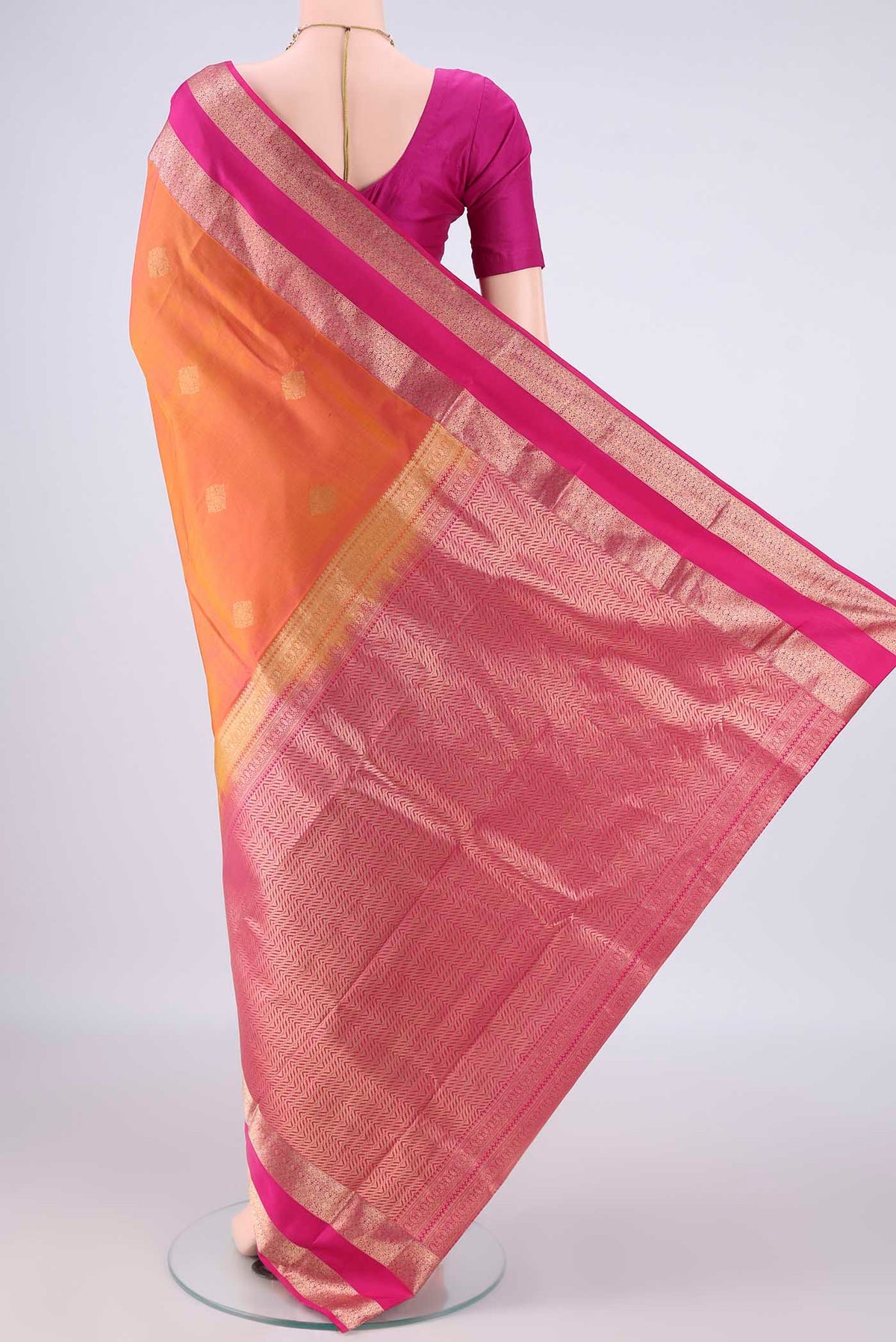 Flat view of Pure Silk Pinkish Yellow Kanchipuram Saree with Zari Butta on the body and Zari Border. 