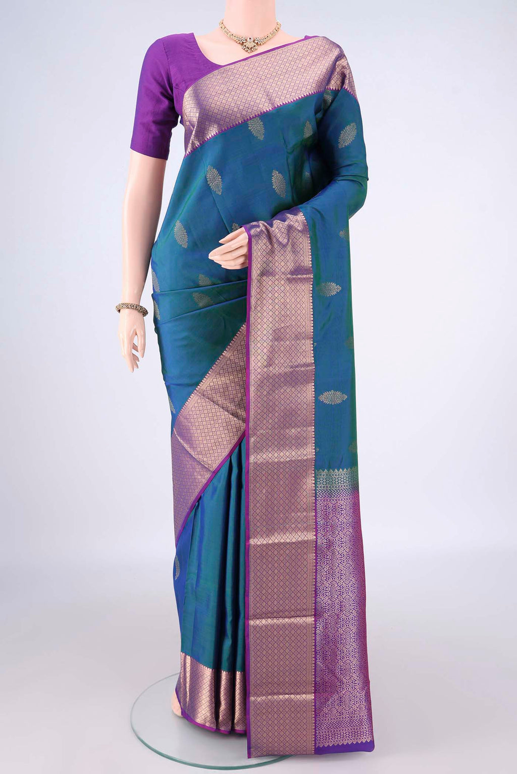 Pure Silk Peacock Blue Dual Tone Kanchipuram Saree with Zari Butta on the body and Zari Border.  displayed on a mannequin