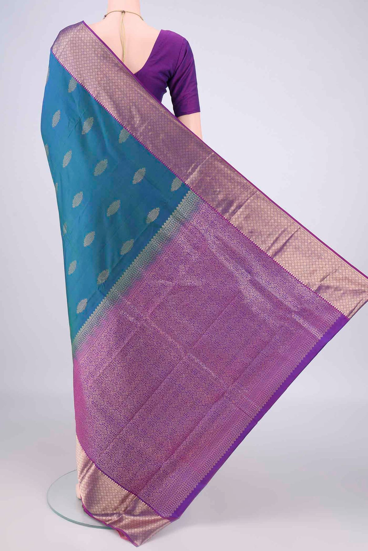 Flat view of Pure Silk Peacock Blue Dual Tone Kanchipuram Saree with Zari Butta on the body and Zari Border. 