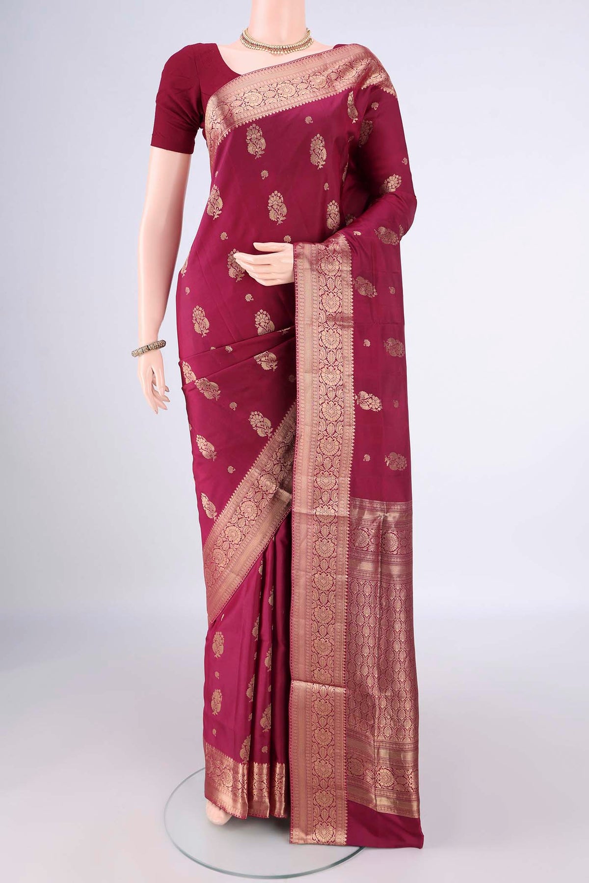 Pure Silk Maroon Soft Saree with Zari Butta on the body and Zari Border.  displayed on a mannequin