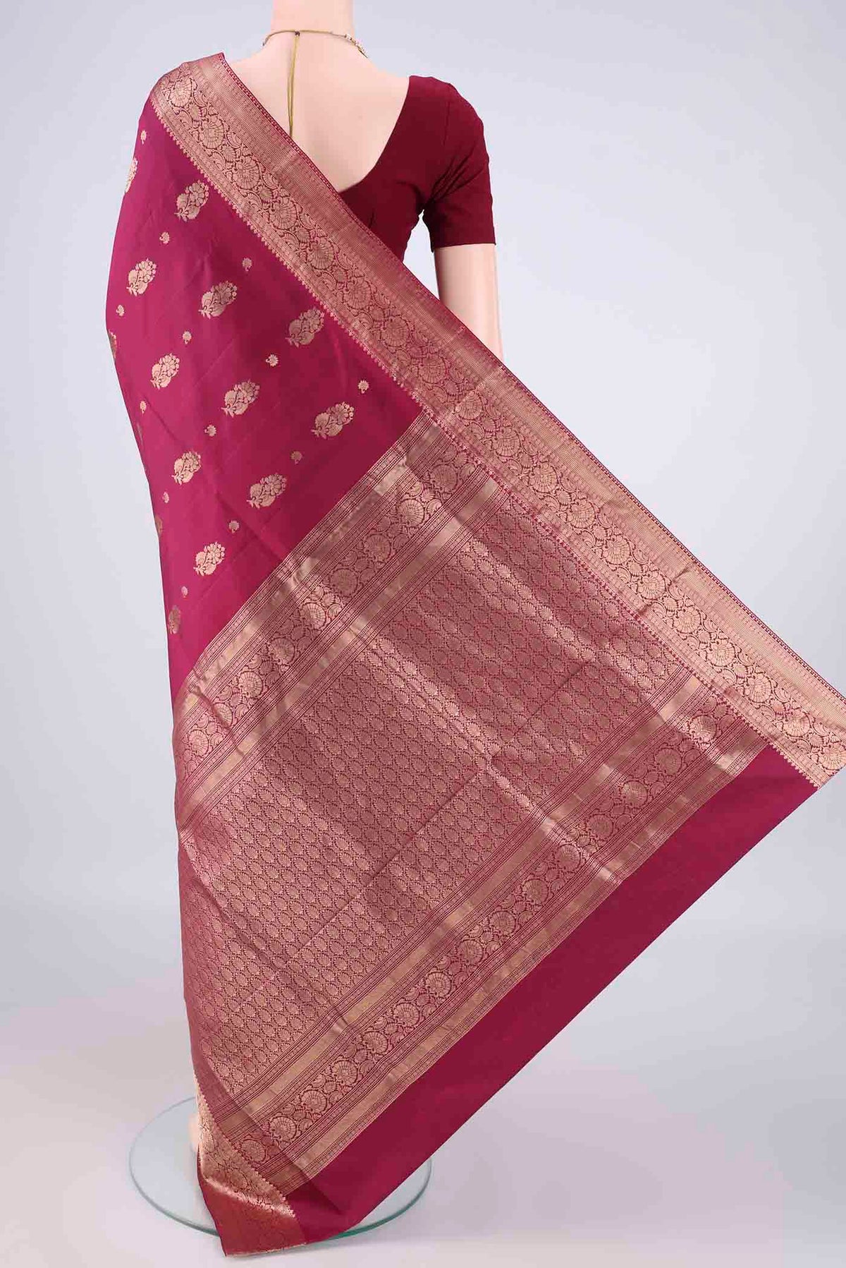 Flat view of Pure Silk Maroon Soft Saree with Zari Butta on the body and Zari Border. 