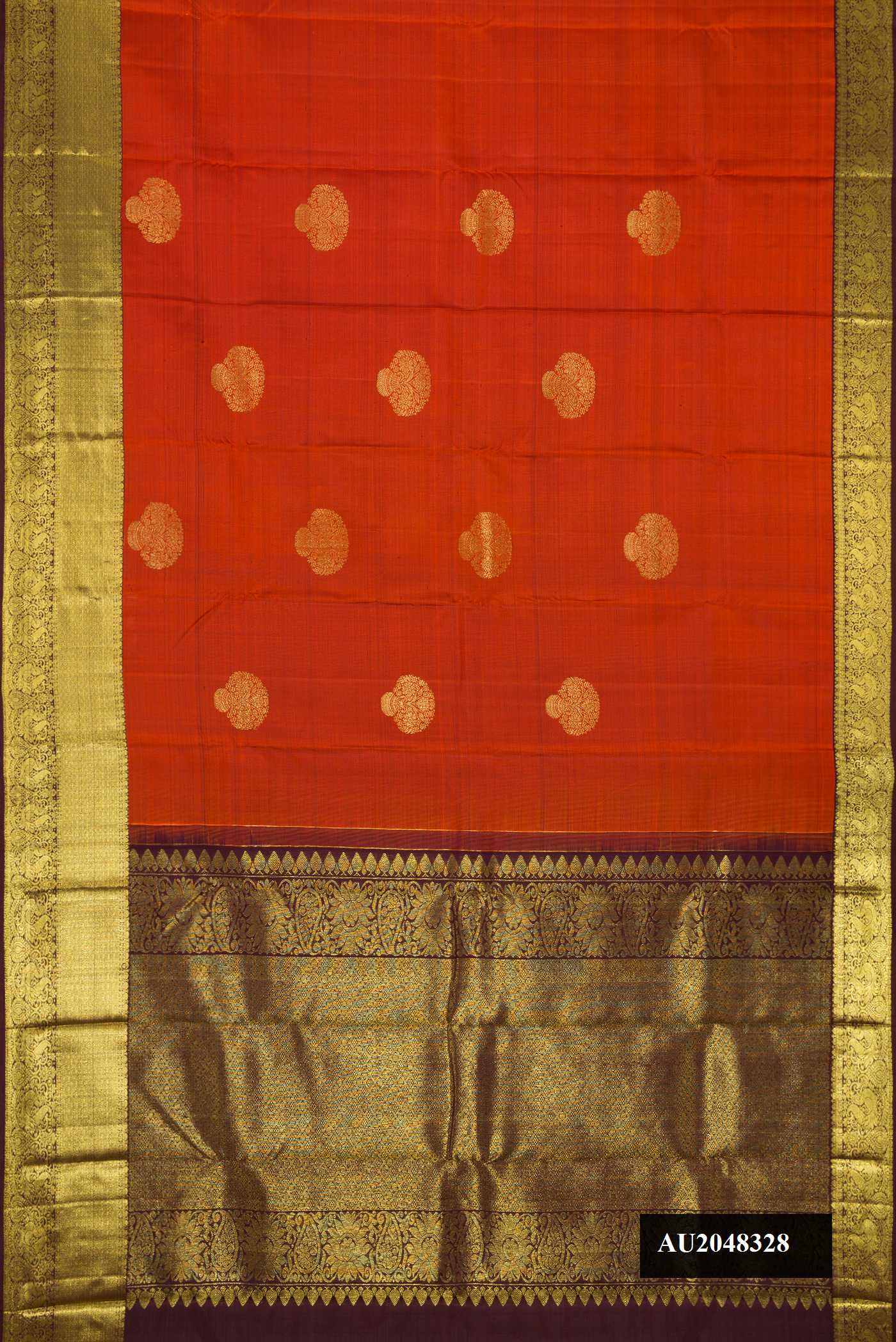 Brick Orange Dual Tone Kanchipuram Silk Saree with Zari Butta on the body and Zari Border.  displayed on a mannequin