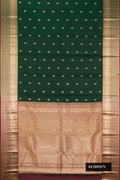 Green Dual Tone Kanchipuram Silk Saree with Zari Butta on the body and Zari Border.  displayed on a mannequin