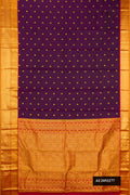 Burgundy Dual Tone Kanchipuram Silk Saree with Zari Butta on the body and Zari Border.  displayed on a mannequin