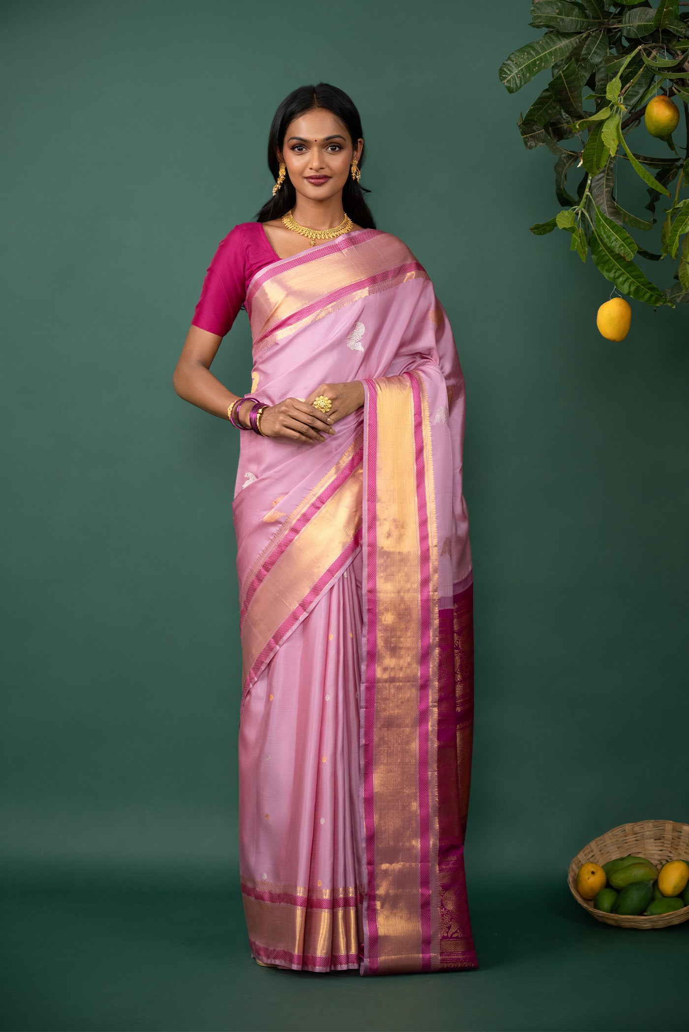 Pink Kanchipuram Silk Saree with Zari Butta on the body and Zari And Thread Border displayed on a mannequin