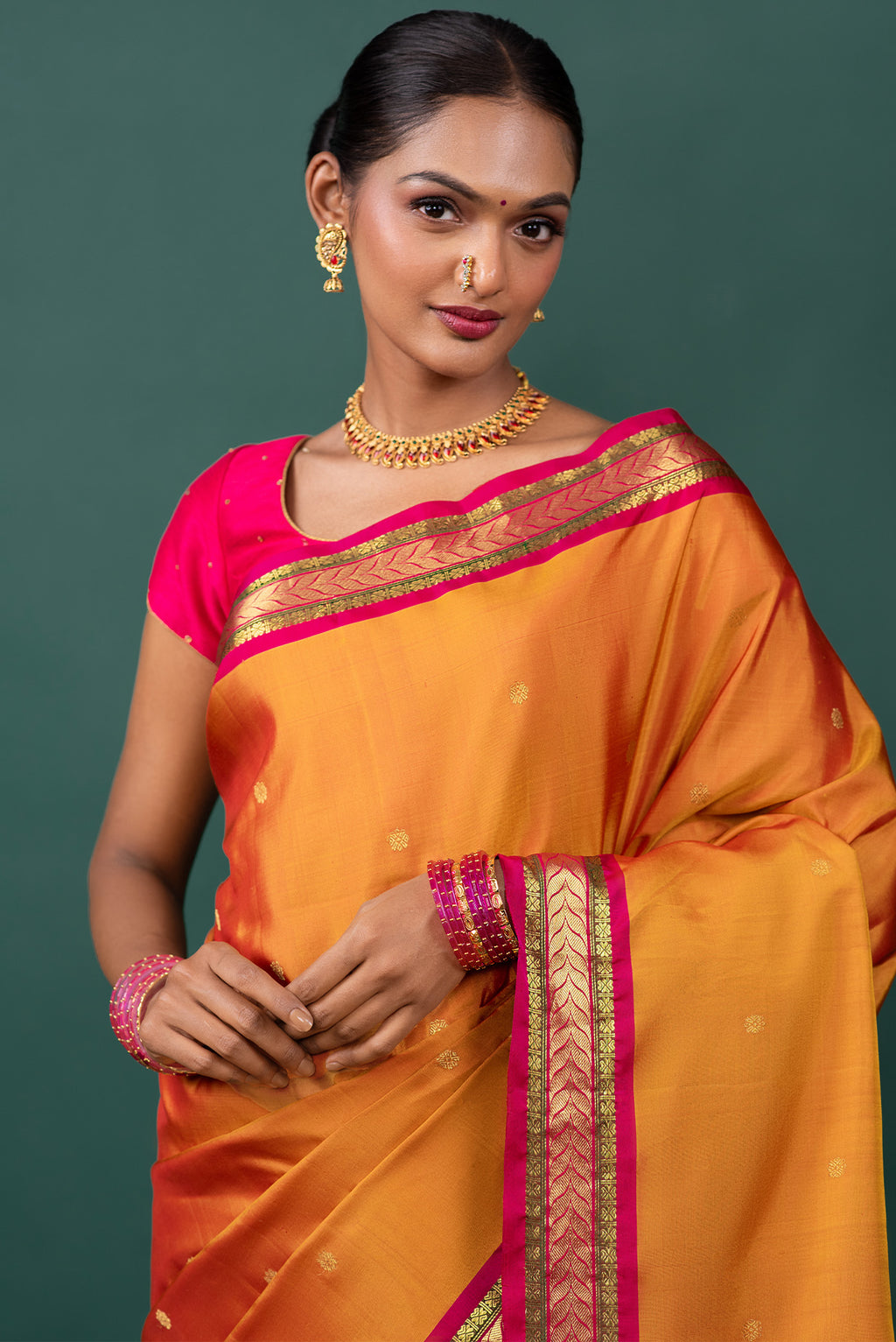 Close up of Mustard Kanchipuram Silk Saree with Zari Butta on the body and Zari Border displaying folds