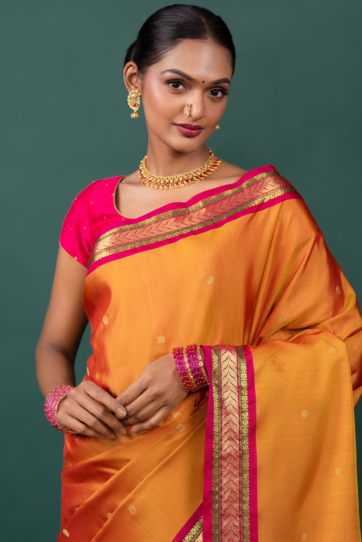 Close up of Mustard Kanchipuram Silk Saree with Zari Butta on the body and Zari Border displaying folds