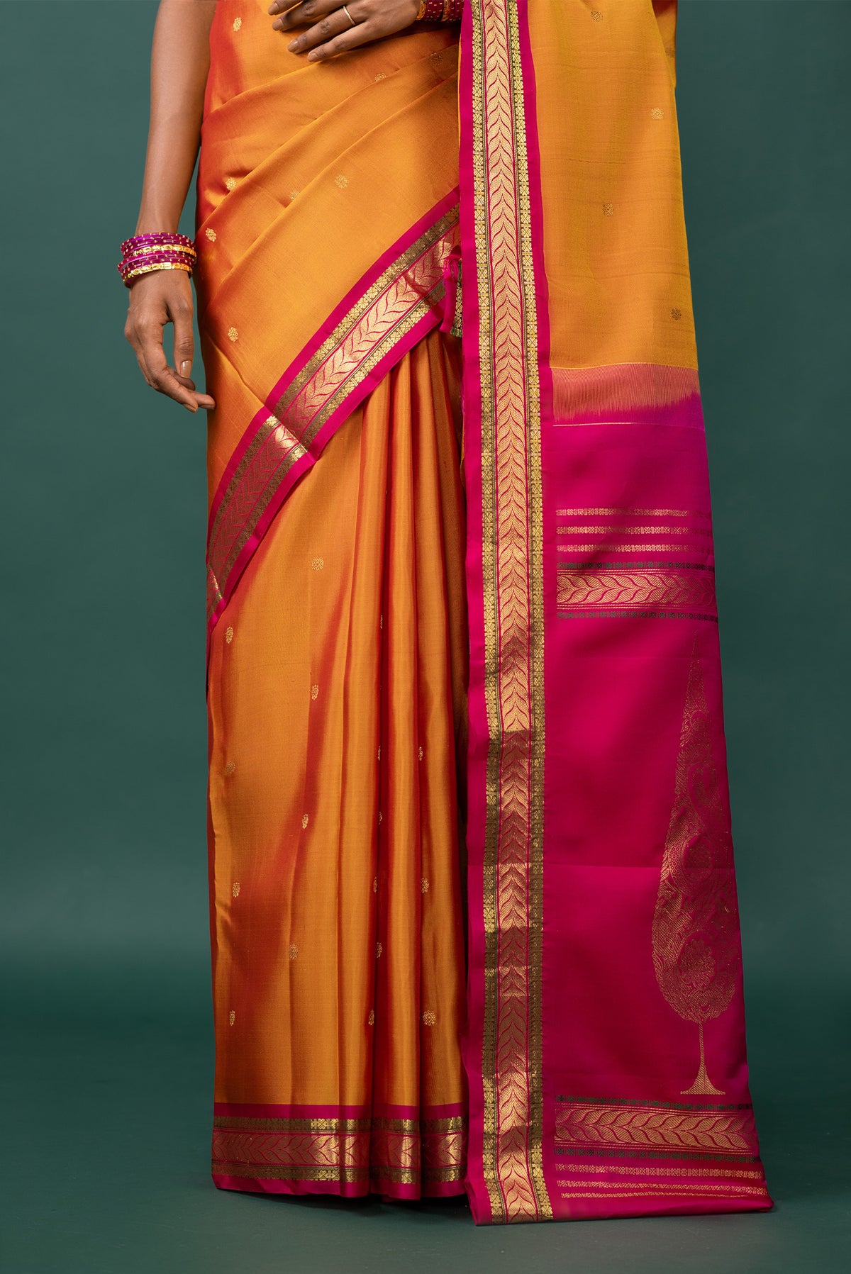 Pleats and pallu of Mustard Kanchipuram Silk Saree with Zari Butta on the body and Zari Border