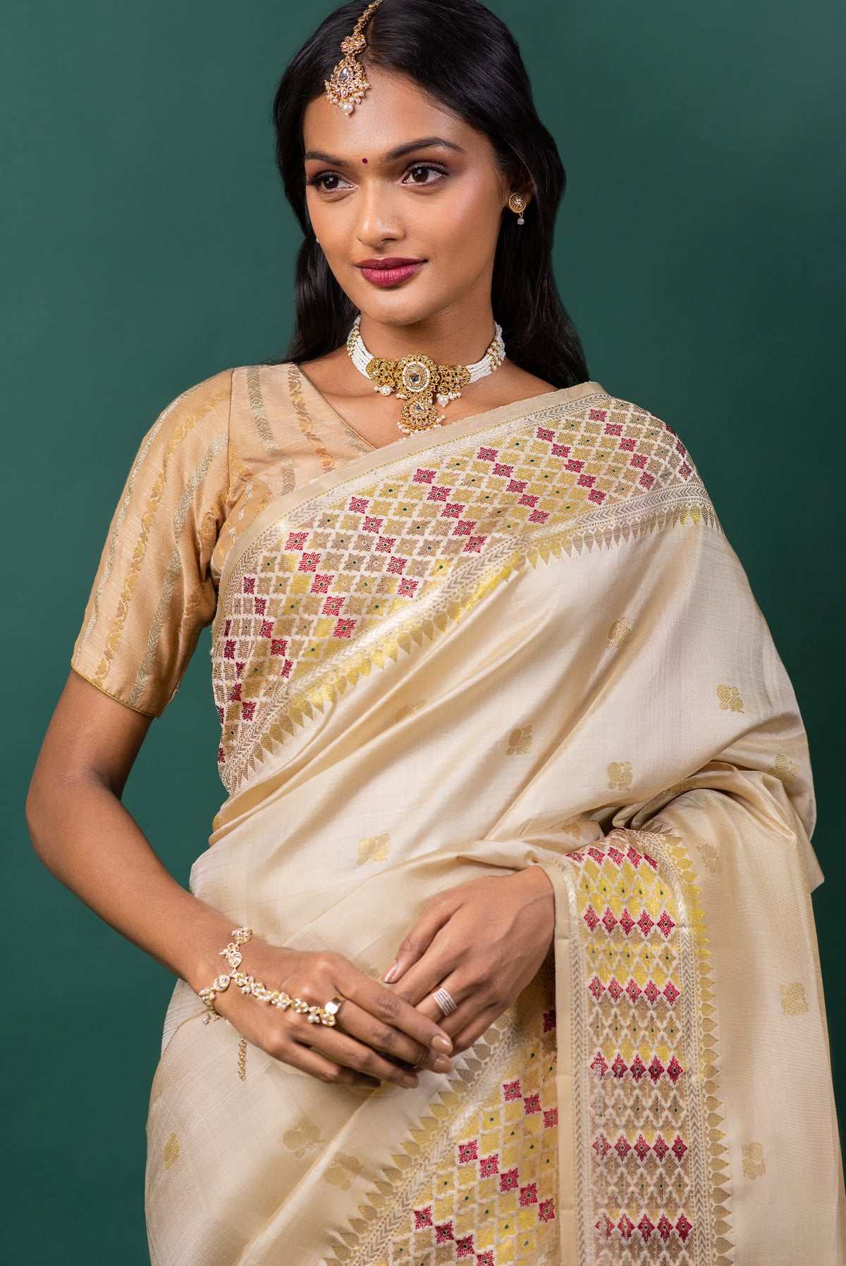 Close up of Beige Kanchipuram Silk Saree with Zari Butta on the body and Zari And Thread Border displaying folds